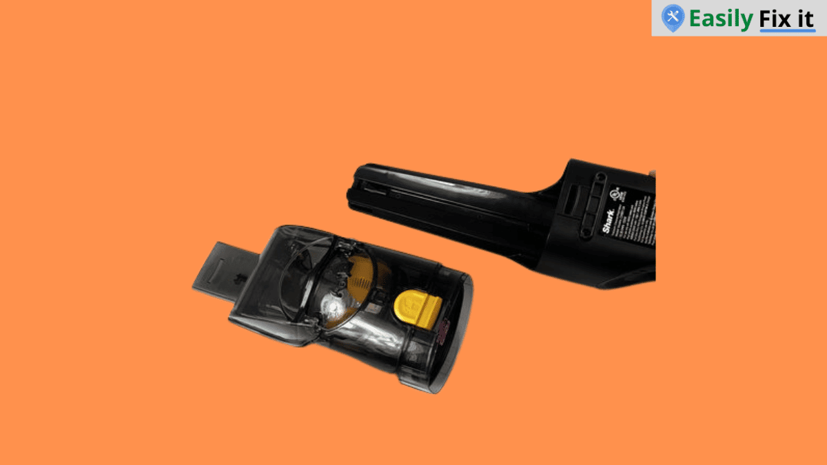 Pressing the release button to remove a Shark cordless vacuum battery